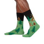 Lifestyle shot showing Sasquatch Camp Out socks on a person's legs, showcasing the design from a slightly different angle.