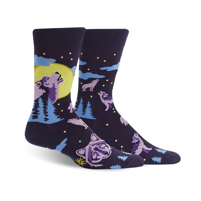 dark blue crew socks feature howling purple wolves and pine trees illuminated by a full moon. fall-themed design for men.   }}