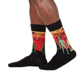 Lifestyle shot of a person wearing the 'They're Here' alien socks. Shows how the socks look when worn.