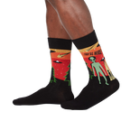 Lifestyle shot of a person wearing the 'They're Here' alien socks. Shows how the socks look when worn.