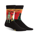 Black crew socks with a retro alien abduction scene in orange, green, and red. The text 'They're Here!' is featured.
