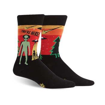 black crew socks with colorful ufo scene and "they're here!" lettering; a humorous pick for sci-fi fans.    