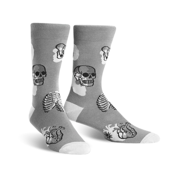 mens crew-length gray socks feature a pattern of black and white skulls, rib cages, and hearts. 