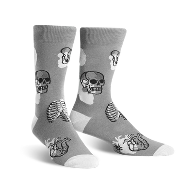 mens crew-length gray socks feature a pattern of black and white skulls, rib cages, and hearts. 