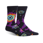 A pair of crew socks with a space-themed design.  The dark background features swirling nebulas in purple, orange, and teal, along with yellow stars.