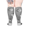 Back view of the anatomical socks on a model's legs.  Shows the full design of the socks, including brains and pelvis bones.