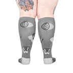 Back view of the anatomical socks on a model's legs.  Shows the full design of the socks, including brains and pelvis bones.