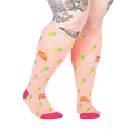 Lifestyle shot of a person wearing the 'GRL PWR' knee-high socks, showcasing the fit and design.