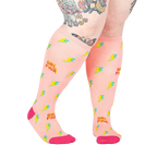 Lifestyle shot of a person wearing the 'GRL PWR' knee-high socks, showcasing the fit and design.