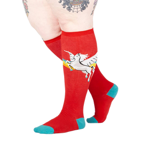 Lifestyle shot of model wearing red Retro Pegasus knee-high socks.