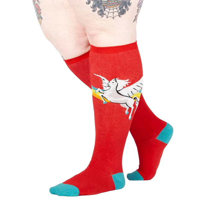 Lifestyle shot of model wearing red Retro Pegasus knee-high socks.