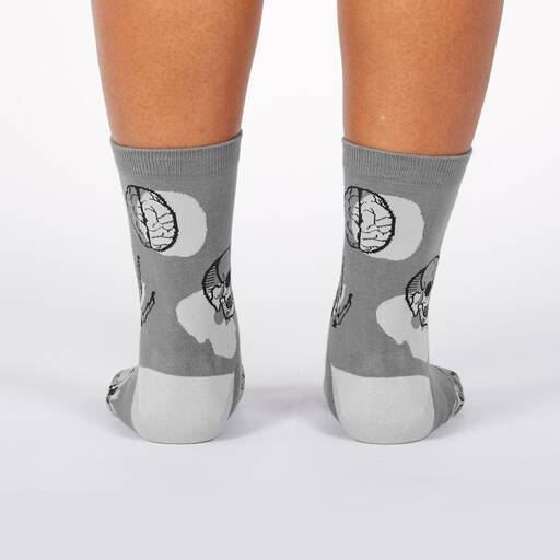 A pair of gray socks with a pattern of brains and skulls.