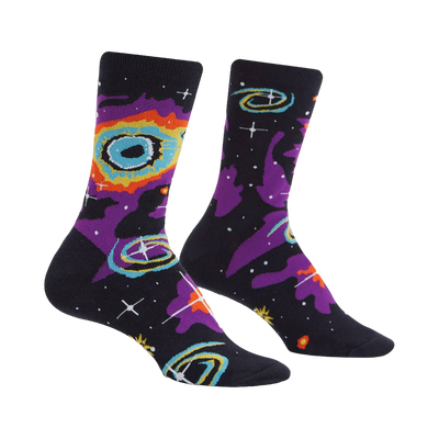 Crew socks in black with a purple, orange, and yellow nebula pattern and white stars.