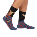 Lifestyle shot of a person's legs wearing the 'All Bundled Up' socks. The socks feature a moose wearing a scarf and snowflake pattern.