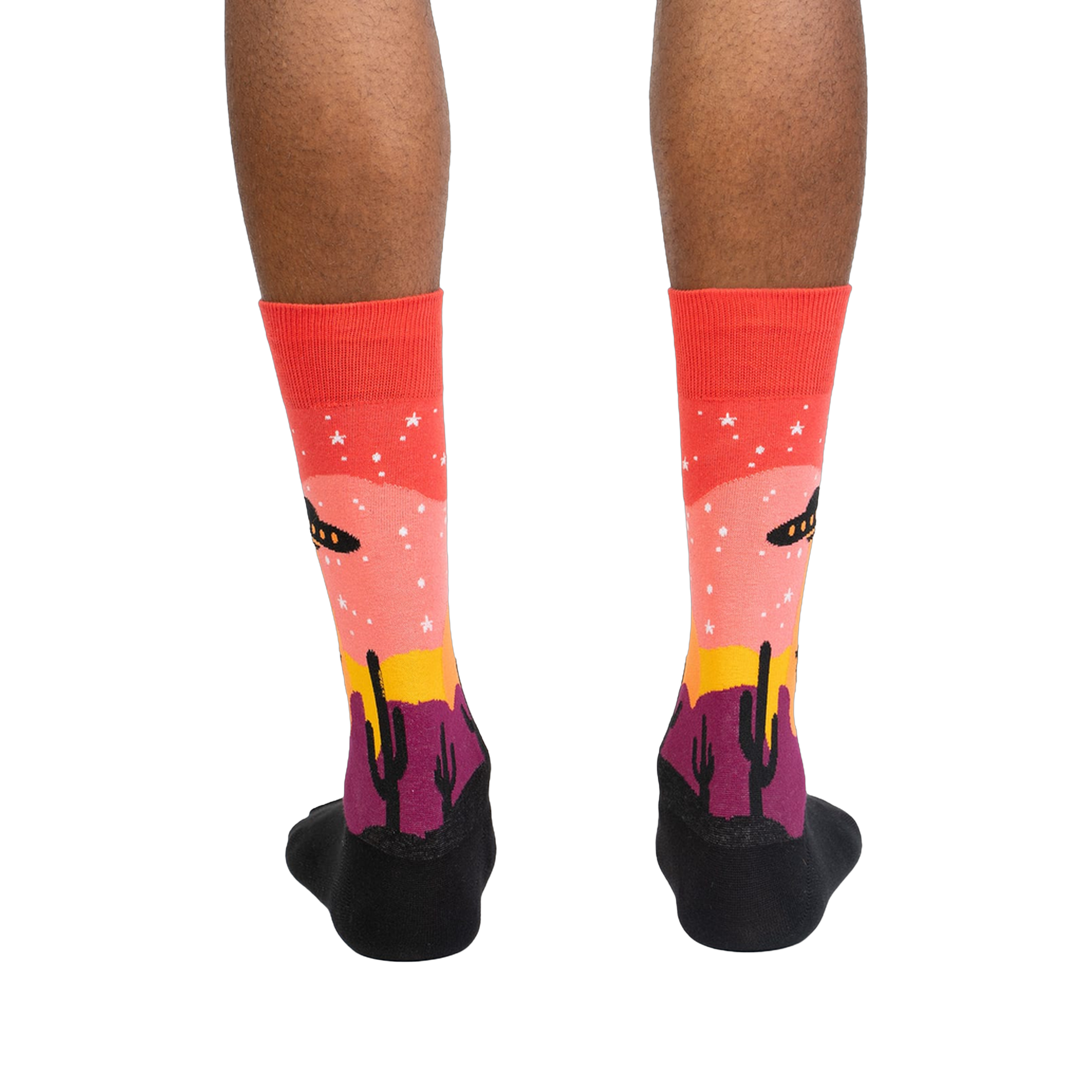 Rear view of a person's legs wearing the Area 51 socks.  The socks' design is fully visible.