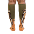 Rear view of a person wearing a pair of Meerkat Manner knee-high socks, showing the full meerkat design on both socks.