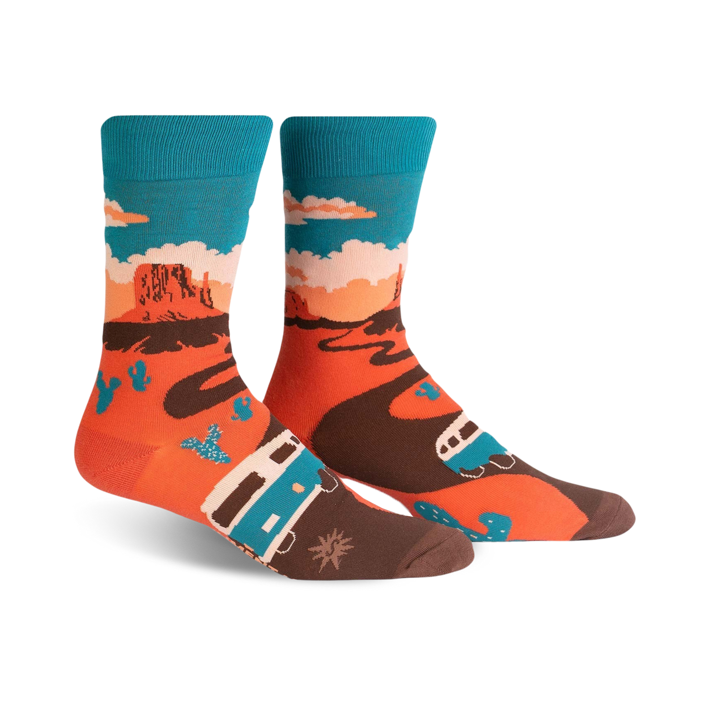 A pair of crew socks showcasing a Monument Valley scene. The socks are orange, teal, and brown, depicting a camper van driving along a desert road with cacti and rock formations.