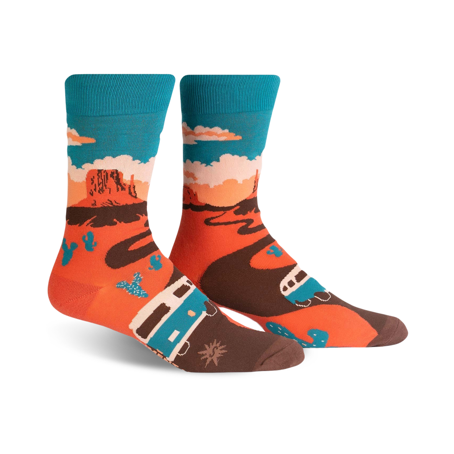 A pair of crew socks showcasing a Monument Valley scene. The socks are orange, teal, and brown, depicting a camper van driving along a desert road with cacti and rock formations.