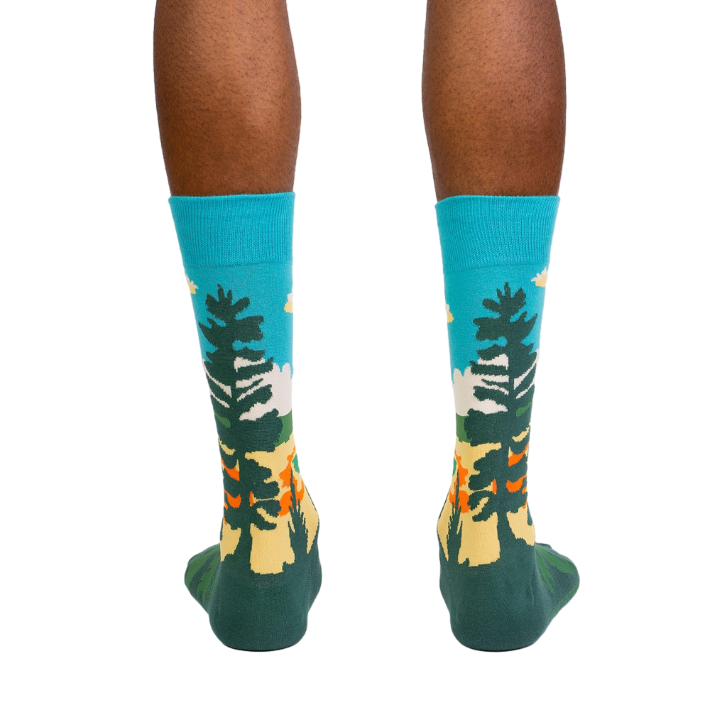 Rear view of model wearing Grand Prismatic socks, highlighting the full sock design.