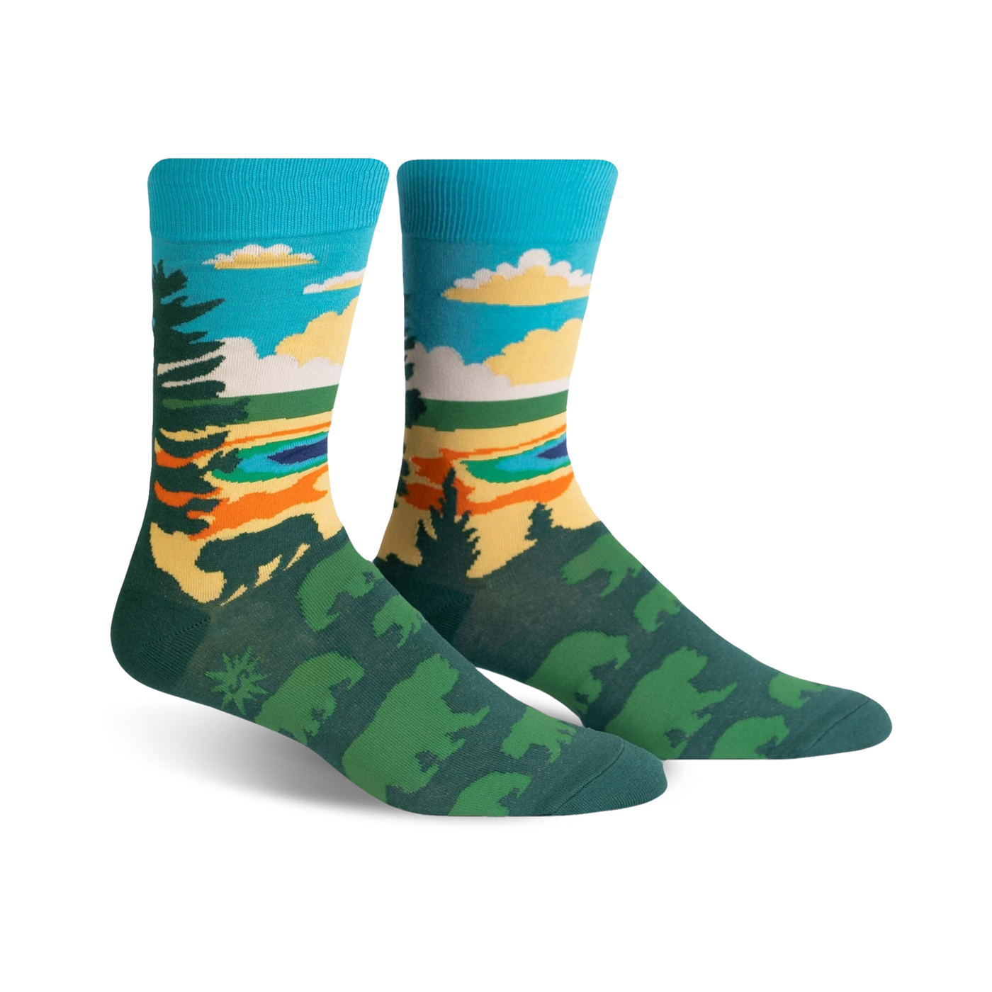 Pair of crew socks showcasing a nature scene. Teal, green, and orange colors depict trees, a lake, and sky. Fun, artistic design.