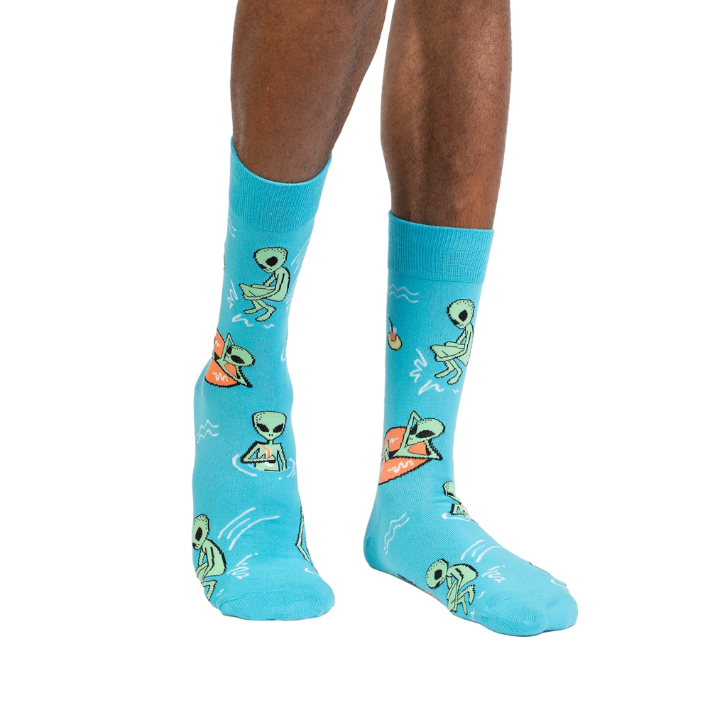 Lifestyle shot of a person wearing the turquoise 'Unknown Floating Object' socks.