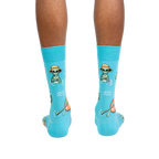 Rear view of a person modeling the turquoise crew socks, showcasing the full alien design.