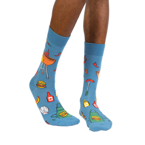 Lifestyle photo showing the 'Grillin' It' socks on a person's legs against a white background.