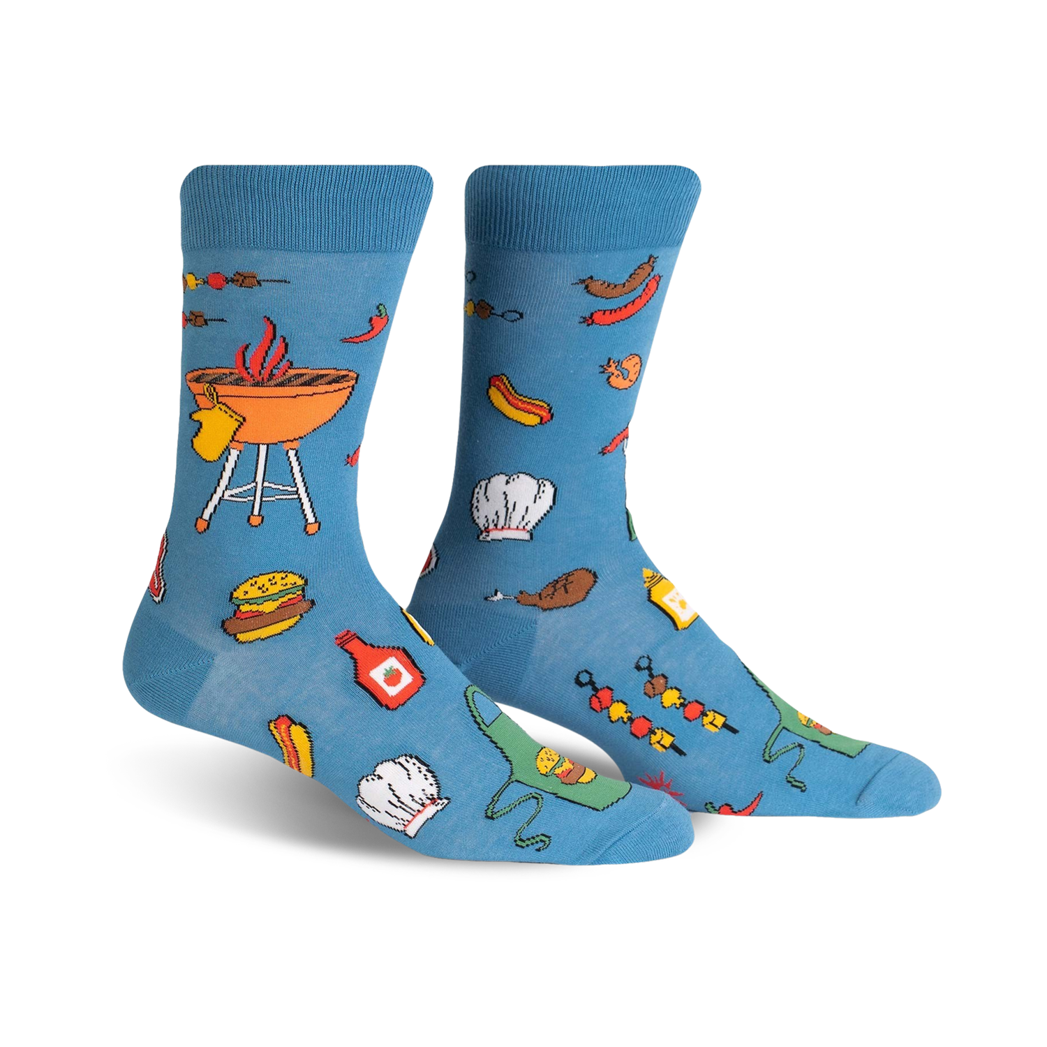 A pair of light blue crew socks with a fun BBQ design featuring burgers, hot dogs, grilling equipment, and chef hats.