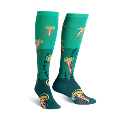 teal knee-high socks with orange jellyfish and yellow tentacle pattern, dark teal toe and heel with green plant accents.   