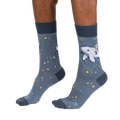 Lifestyle shot showcasing Cosmic Cetacean socks on a person's feet, highlighting the sock's fit and design.
