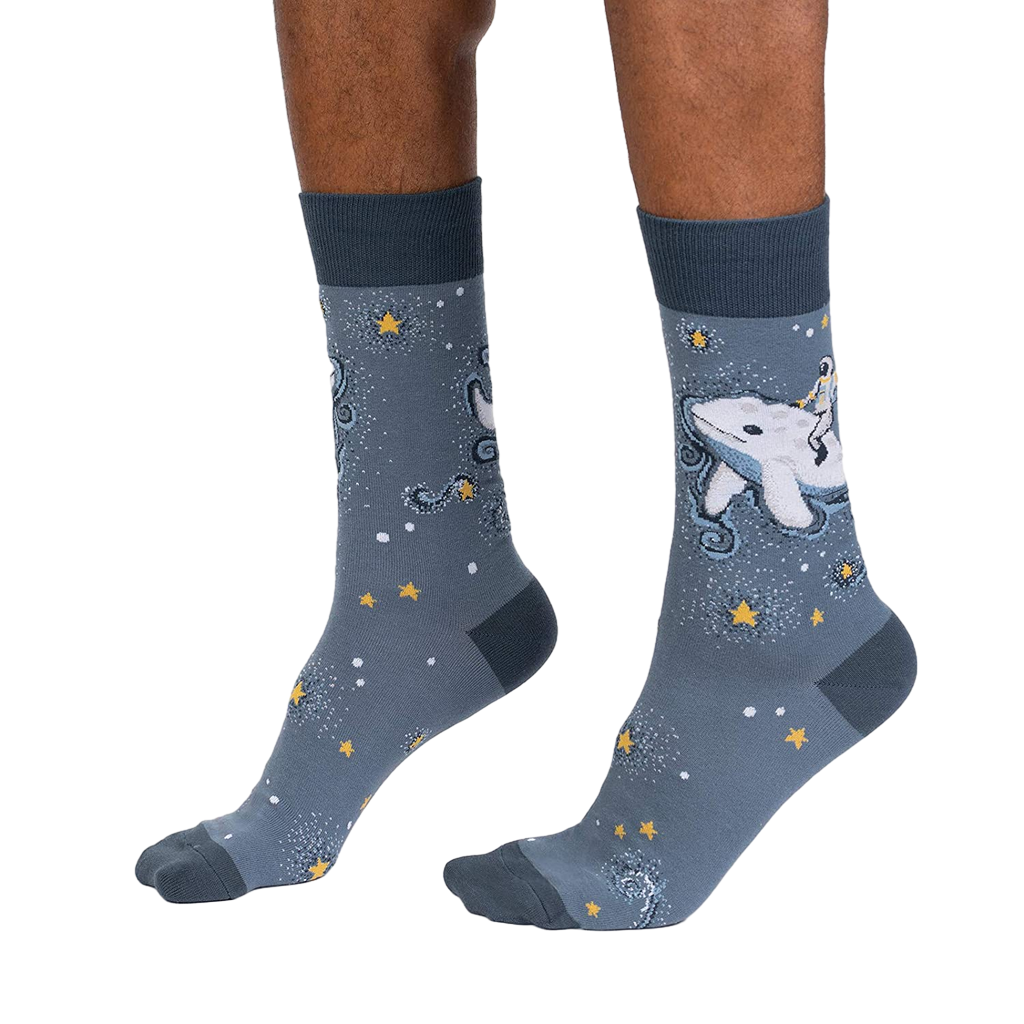 Lifestyle shot showcasing Cosmic Cetacean socks on a person's feet, highlighting the sock's fit and design.