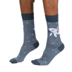 Lifestyle shot showcasing Cosmic Cetacean socks on a person's feet, highlighting the sock's fit and design.