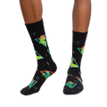 Lifestyle shot of a person modeling the Jurassic Party socks, showing the socks on their feet.