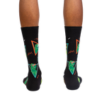 Back view of the Jurassic Party socks on a person's feet.
