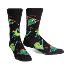 Pair of black crew socks with green dinosaurs wearing sunglasses, set against a 90s-style geometric pattern. 