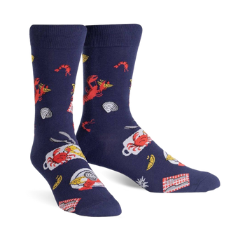 Pair of navy blue crew socks with a whimsical design featuring red lobsters, crabs, lemon slices, and other seafood boil elements.