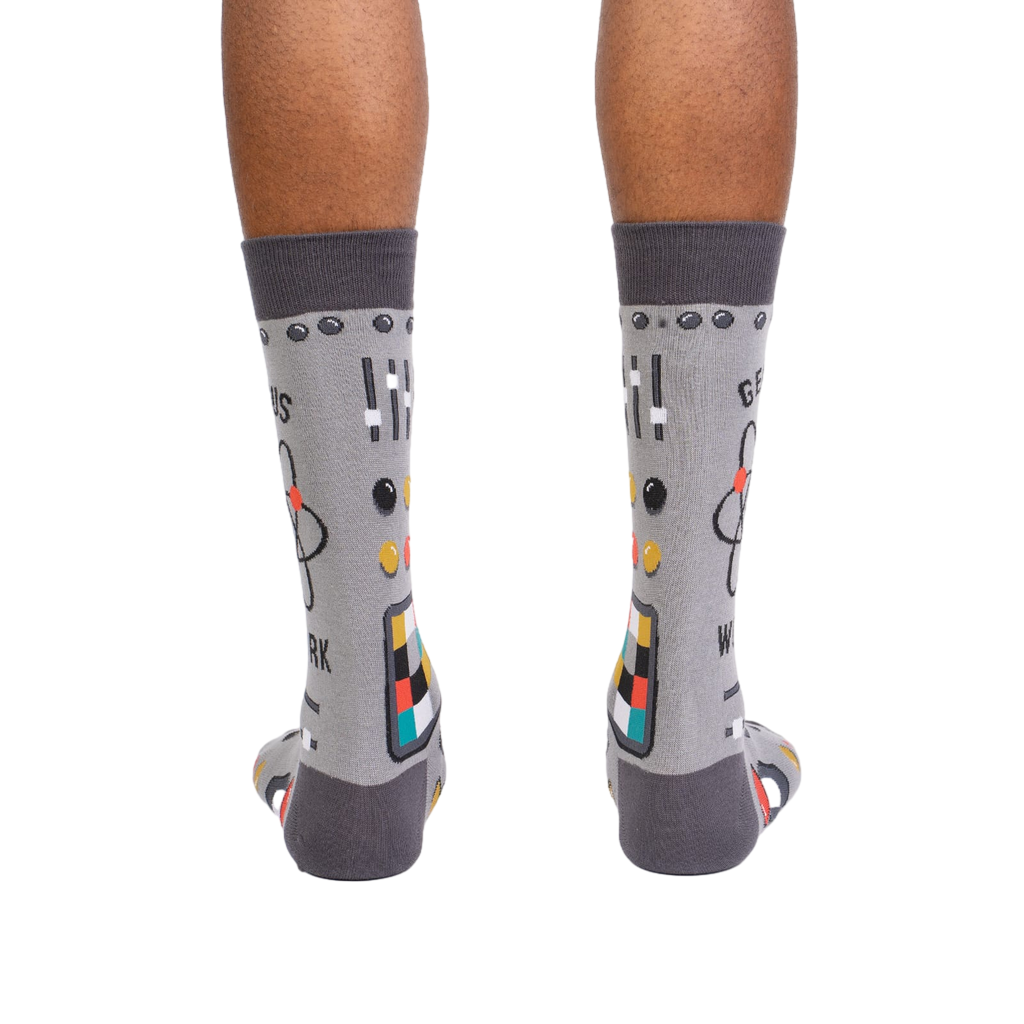 Rear view of a pair of gray 'Genius at Work' socks, showing the full design on the back of each sock.