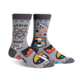 Pair of gray crew socks with a robot control panel design, atom graphic, and the phrase 'Genius at Work'. Features pops of orange, teal, and yellow.