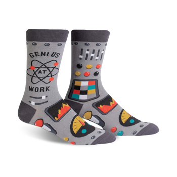 crew socks in gray with gears, cogs, and mechanical elements. "genius at work" text on left sock.  
