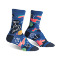 Pair of women's crew socks in navy blue. Features glow-in-the-dark planets, feminist symbols, and the text 'You Glow Girl!'