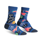 Pair of women's crew socks in navy blue. Features glow-in-the-dark planets, feminist symbols, and the text 'You Glow Girl!'