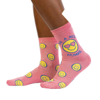 Lifestyle shot showing the 'Be a Nice Human' socks on a model's legs.