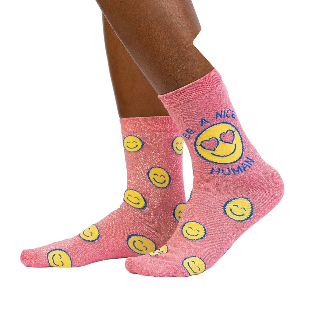 Lifestyle shot showing the 'Be a Nice Human' socks on a model's legs.