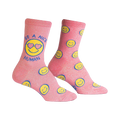Crew socks in pink with glitter.  The design features yellow smiley faces and the phrase 'Be a Nice Human' on one sock.