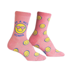 Crew socks in pink with glitter.  The design features yellow smiley faces and the phrase 'Be a Nice Human' on one sock.