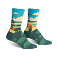 A pair of crew socks with a scenic nature design. The socks are teal, green, yellow, and orange, depicting a landscape with bears.