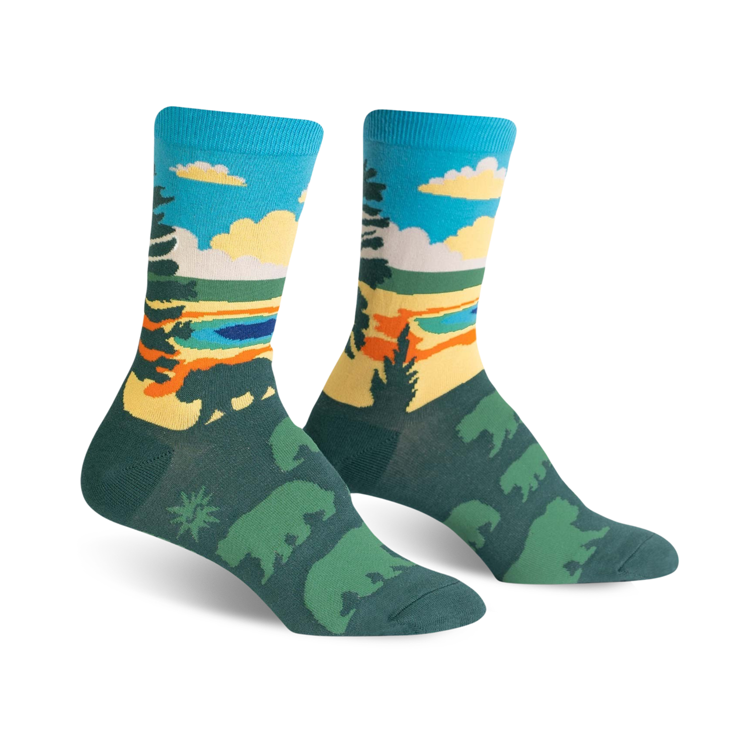 A pair of crew socks with a scenic nature design. The socks are teal, green, yellow, and orange, depicting a landscape with bears.
