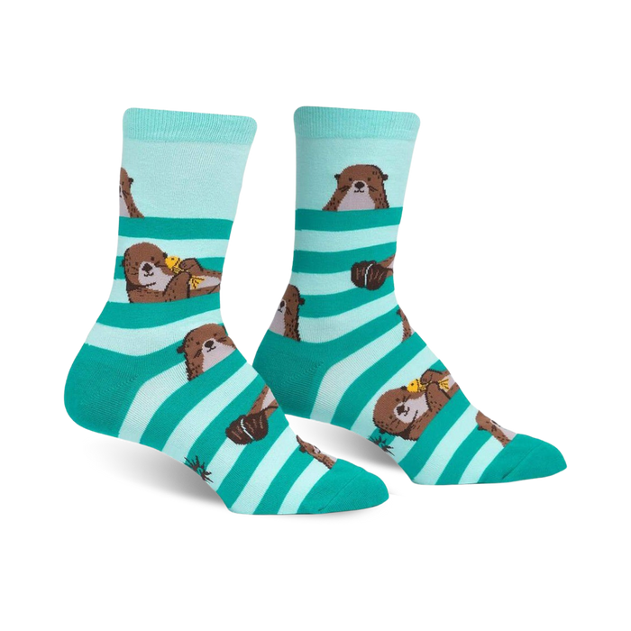 women's crew-length socks featuring a pattern of sea otters holding yellow and orange fish.  