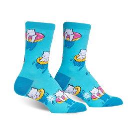 light blue "hangin meowt" women's crew socks depict white cats swimming in pink sunglasses on inner tubes, set against a background of blue and yellow stars.    