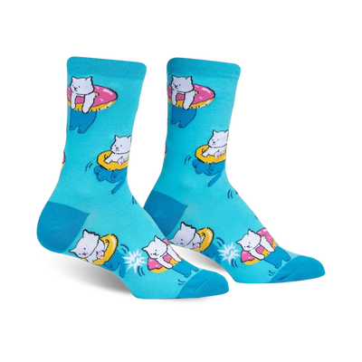 light blue "hangin meowt" women's crew socks depict white cats swimming in pink sunglasses on inner tubes, set against a background of blue and yellow stars.    